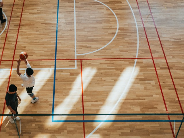Man taking a shot on basketball court