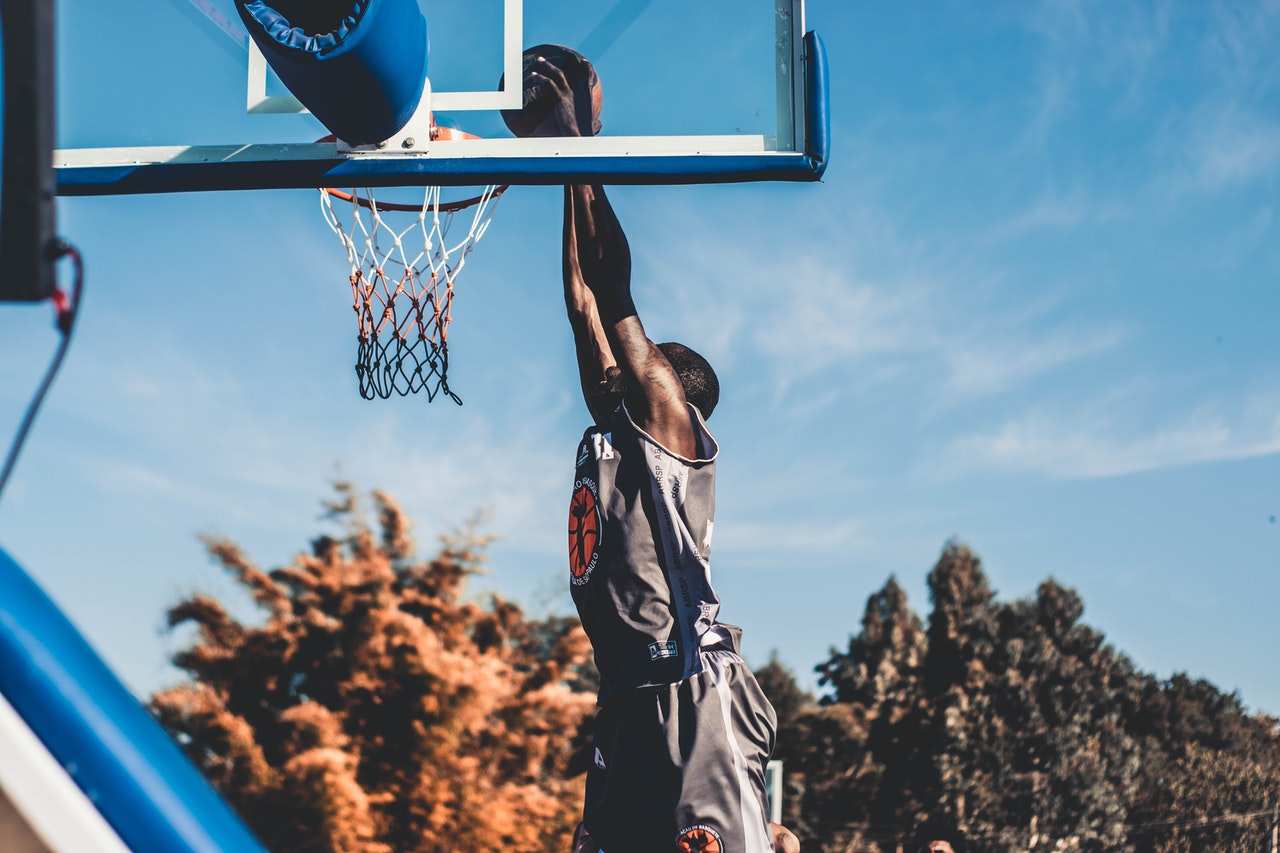 man dunking a basketball